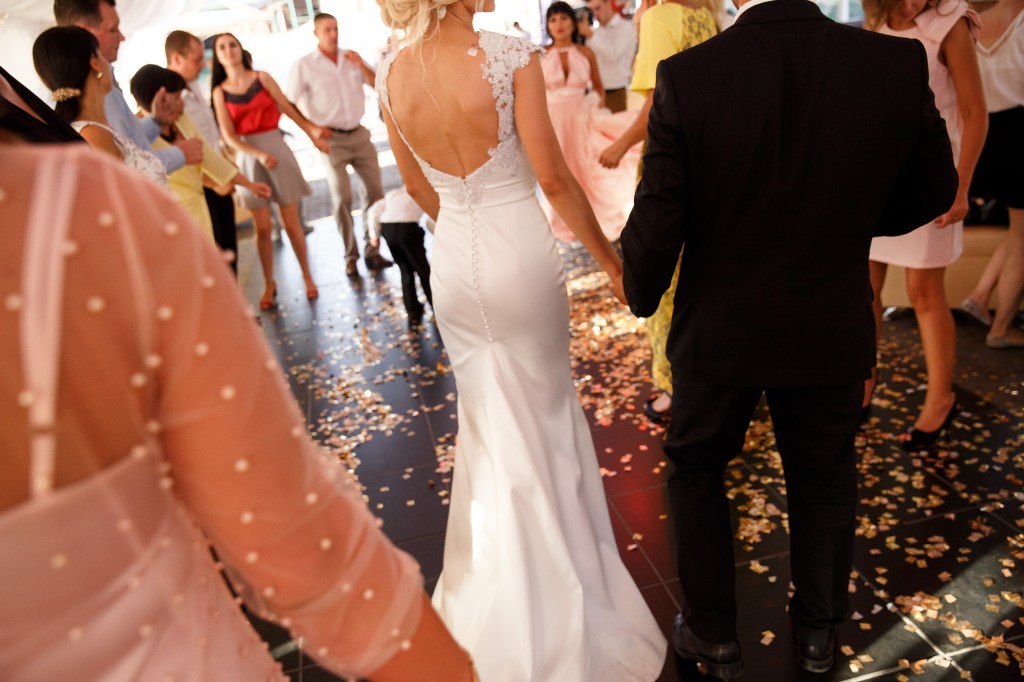 Wedding couple, bride and groom with wedding guests